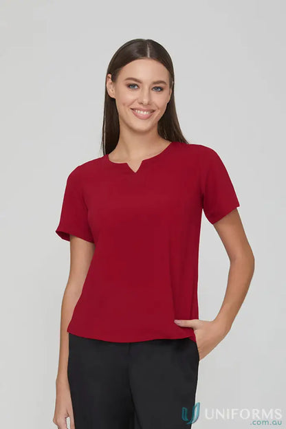 Woman in red top and black pants from City Collection Knit woven short sleeve set