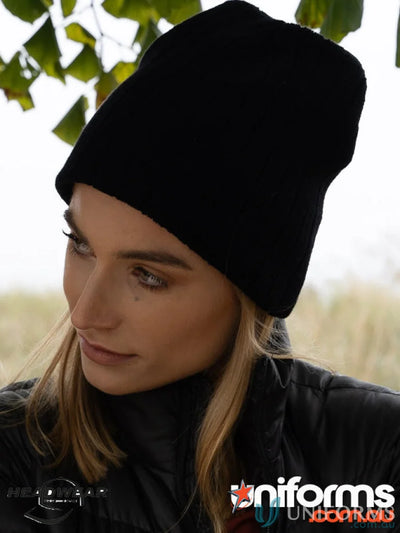 Black cable knit beanie on display showcasing cozy cable knit style