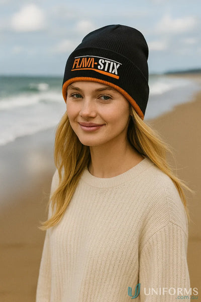 Black cable knit beanie with orange trim and FLAVA-STIX logo for style and warmth