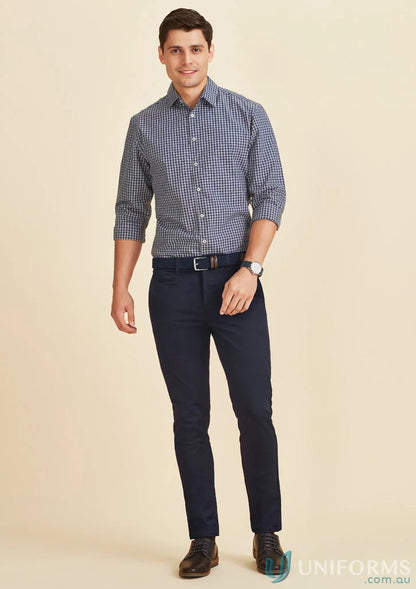 Man in checkered shirt and navy pants wearing men’s Traveller Tapered Stretch Chino RGP263M