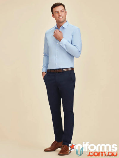 Man in blue dress shirt and navy pants wearing Traveller Tapered Stretch Chino RGP263M