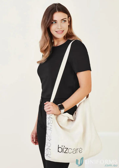 Cream-colored Unisex Biz Care Tote Bag with black text and stylish strap pattern