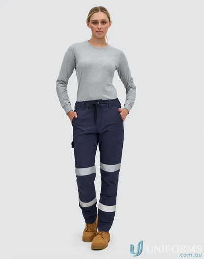 Woman wearing unisex DWR water repellent flexi work pants and long-sleeved shirt