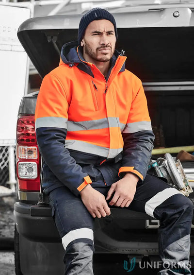 Man in high-vis Unisex HiVis Antarctic Softshell Jacket with fleece-lined hand warmers
