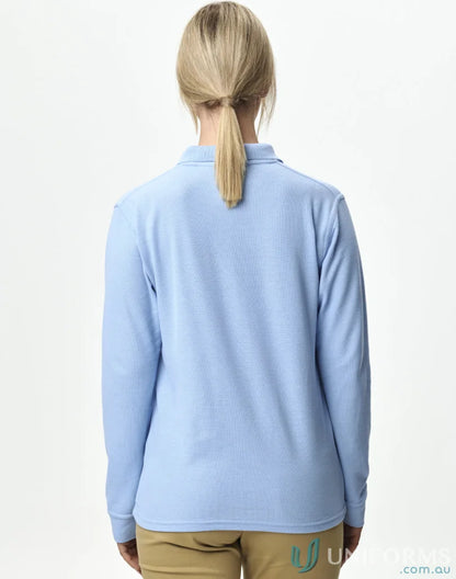 Woman wearing a light blue long sleeve polo shirt in Unisex Pique LS Polo featuring traditional poly cotton