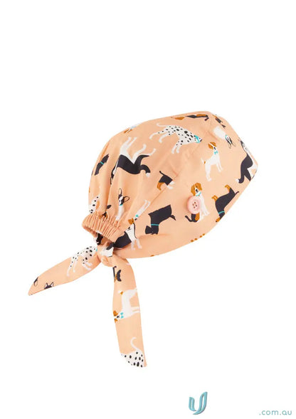Peach-colored unisex printed scrub cap with cute dog pattern for adding personality