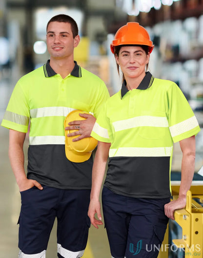 Two workers in safety gear wearing SW85 Unisex cooldry segmented polo with matching colour buttons
