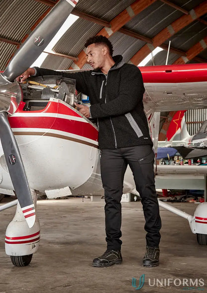 Man in black work pants and fleece zt285 inspecting airplane engine in super warm zip sherpa fleece