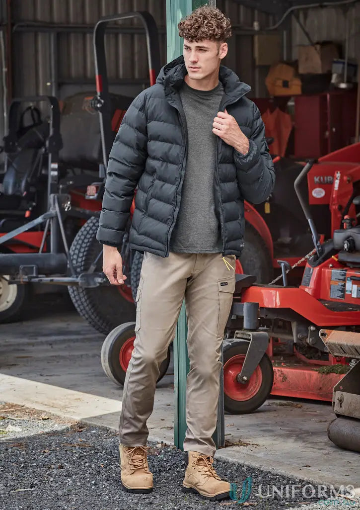 Man in workwear wearing the Unisex Streetworx Hooded Puffer Jacket, perfect for outdoor streetwear