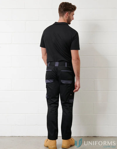 Men’s black utility stretch cargo work pants with tan work boots and polo shirt
