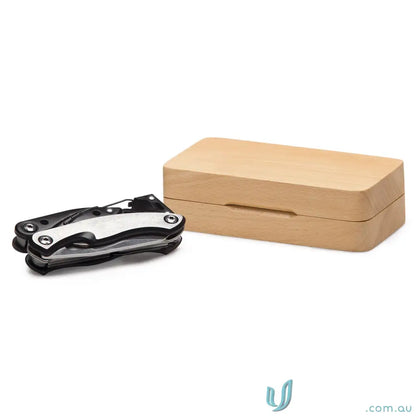 Closed VersaGrip Multi Tool with 420J2 Drop Blade next to wooden box in stainless steel style