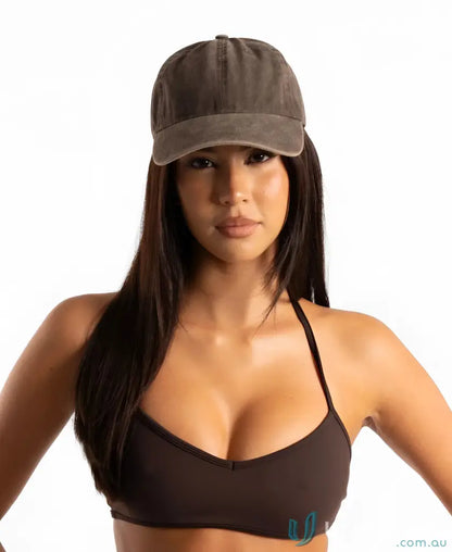 Woman wearing a vintage washed cap and sports bra for a cool casual look