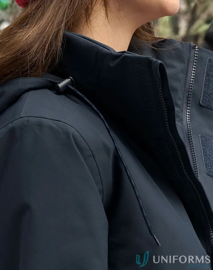 Woman in waterproof quilted jacket with hood, perfect workwear to stay dry outdoors