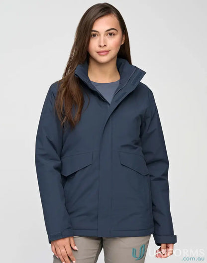 Woman modeling navy waterproof quilted jacket with high collar and front pockets for workwear