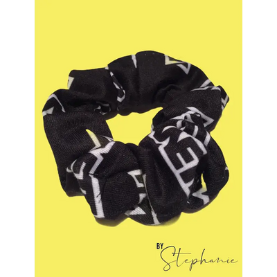 Black scrunchie with bold white geometric lettering perfect for adding style to uniforms and workwear looks