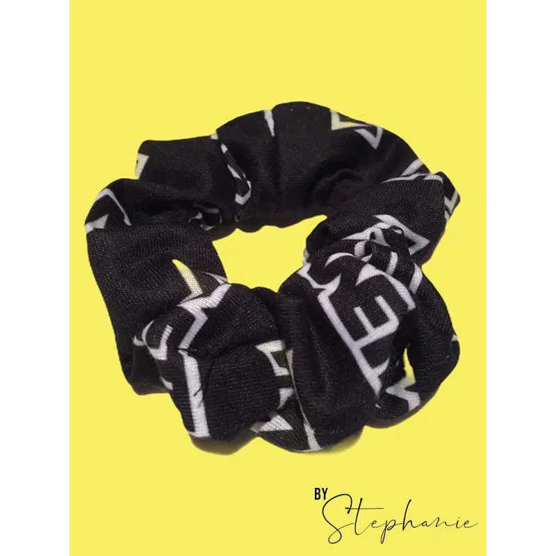 Black scrunchie with bold white geometric lettering perfect for adding style to uniforms and workwear looks