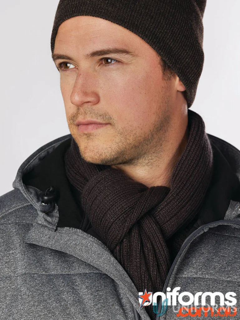 Man wearing Winning Spirit Cable Knit Scarf with dark brown beanie and grey jacket