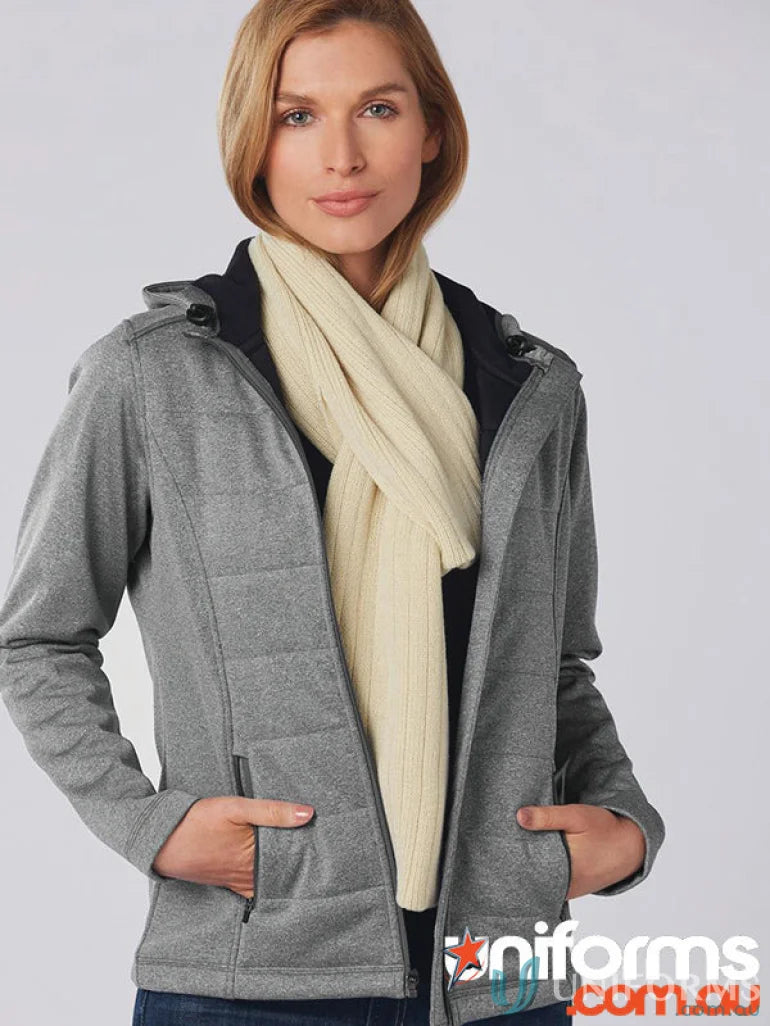 Woman in grey zip hoodie with Winning Spirit Cable Knit Scarf and cream ribbed scarf