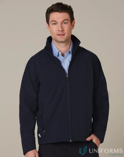 Men’s navy blue zip-up softshell jacket over light blue shirt, ideal for wind resistance work environments