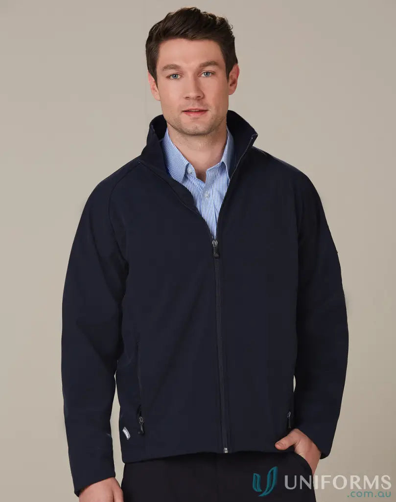 Men’s navy blue zip-up softshell jacket over light blue shirt, ideal for wind resistance work environments