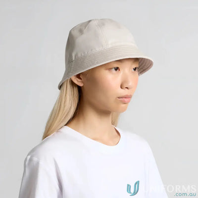 Light gray brim bucket hat with reinforced short brim on blonde-haired person