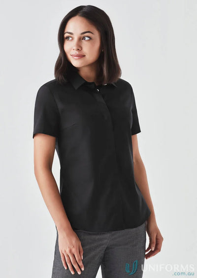 Woman wearing the Women’s Charlie SS Shirt in black showcasing a hidden bust design