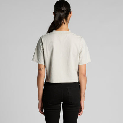Cream faded crop tee with black pants and ponytail