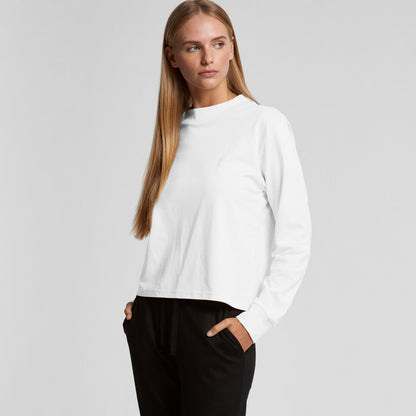 White crew neck sweatshirt with black pants and pockets.