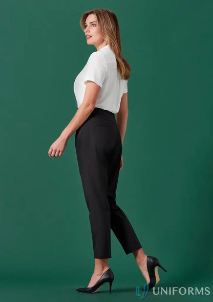 Woman wearing white blouse and black mid-waist slim pants from Womens Renew collection
