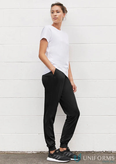 Woman in black sweatpants and white t-shirt showcasing women’s score pant from Biz Collection Women’s