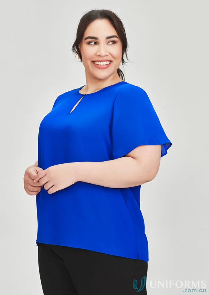 Woman in a blue Vienna SS blouse with fluted sleeves and easy-care fabric