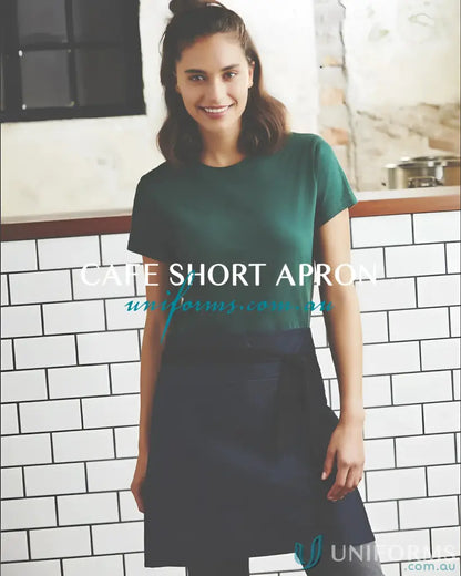 Smiling woman in dark green biz collection short waisted apron from Yes Chef Cafe Short Apron