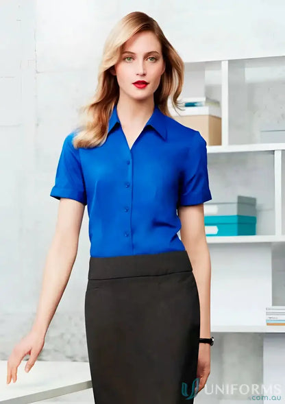 Woman in blue blouse and black skirt wearing YR Ladies EMB SS Shirt with monaco short style