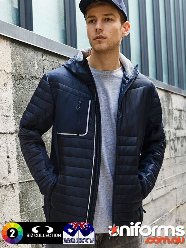 A man wearing a hat and a Biz Collection Unisex Patrol Jacket J134M poses, exemplifying modern outdoor fashion.