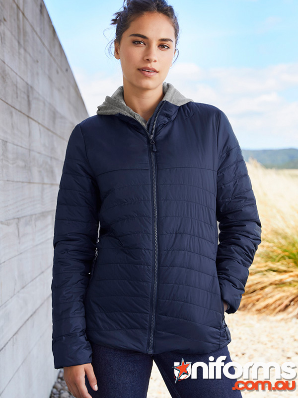 A lady wearing the Biz Collection Navy Ladies Expedition quilted jacket style J750L.