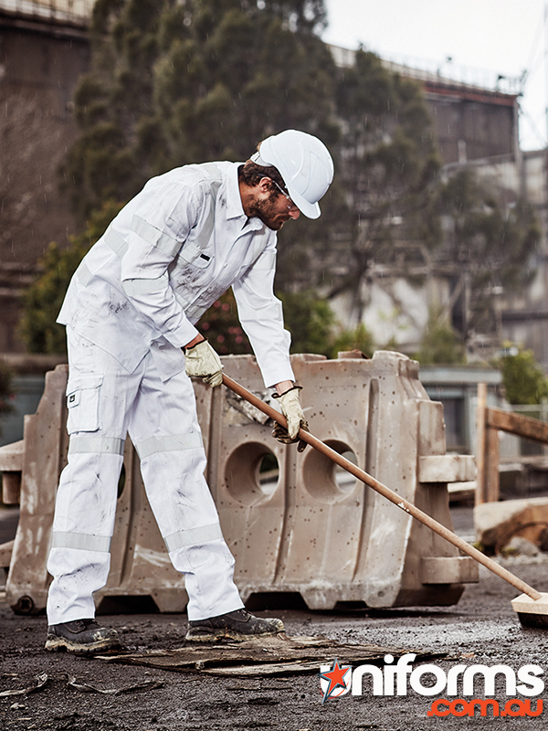 A man in white overalls is engaged in cleaning a concrete block, featuring Syzmic Men’s Bio Motion Taped Pant ZP920.