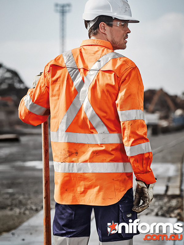 A man wearing an orange safety vest and hard hat, showcasing the Syzmik Men's Hi Vis X Back Taped Long Sleeve Shirt ZW690.