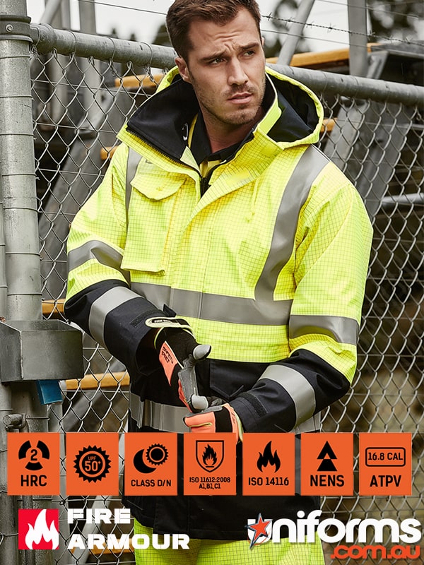 zw133-navy-yellow.jpg_product_product_product_product_product_product_product_product_product A tradie standing beside a fence showcasing Syzmic ZJ900 Men’s Orange Flame Arc Rated Antistatic Waterproof Jacket
